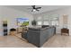 Living room featuring comfortable seating, television, and bright, natural light at 916 Carmillion Ct, Groveland, FL 34736