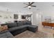 Open-concept living room with large sectional sofa and views of the kitchen and dining area at 916 Carmillion Ct, Groveland, FL 34736
