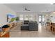 Open-concept living room with large sectional sofa and views of the kitchen and dining area at 916 Carmillion Ct, Groveland, FL 34736