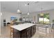 Open concept living space with a kitchen island, dining table, and media area for relaxed, modern living at 916 Carmillion Ct, Groveland, FL 34736