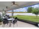 Relaxing screened patio with ceiling fans and a view of the backyard with white vinyl fence at 916 Carmillion Ct, Groveland, FL 34736