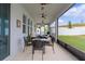 Relaxing screened patio with ceiling fans and a view of the well manicured backyard at 916 Carmillion Ct, Groveland, FL 34736