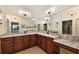 Bathroom featuring a wide mirror, a double sink vanity and modern lighting at 10199 Mainsail Dr, Oxford, FL 34484