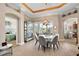 Bright dining room with modern decor, stylish light fixture, and a glimpse of the Primary bedroom at 10199 Mainsail Dr, Oxford, FL 34484