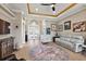 Spacious living room featuring a decorative ceiling, neutral color scheme, and lots of wall decor at 10199 Mainsail Dr, Oxford, FL 34484