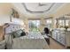 Spacious main bedroom suite featuring trey ceilings, and a sitting area with views of the backyard at 10199 Mainsail Dr, Oxford, FL 34484