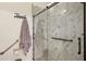 Walk-in shower featuring a modern design, glass doors, and grab bars for accessibility at 10199 Mainsail Dr, Oxford, FL 34484