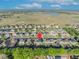 An aerial neighborhood view with lake views and open fields, showcasing the home's location at 10219 Lenox St, Clermont, FL 34711