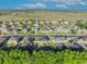 An aerial neighborhood view with lake views and open fields, showcasing the home's location at 10219 Lenox St, Clermont, FL 34711