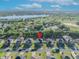 An aerial view of a suburban home, its surrounding neighborhood, and a distant lake at 10219 Lenox St, Clermont, FL 34711