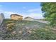 Spacious, partially-shaded backyard with a gentle slope enclosed by a white vinyl fence at 10219 Lenox St, Clermont, FL 34711