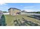 Spacious backyard with a large lawn, brick patio, and tall fence at 10219 Lenox St, Clermont, FL 34711