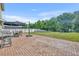 Large backyard with a brick patio, table, umbrella, and grill at 10219 Lenox St, Clermont, FL 34711