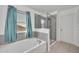 Bright bathroom with a large window and a glass-enclosed shower at 10219 Lenox St, Clermont, FL 34711