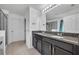 Bathroom vanity features double sinks, granite countertops, and a large mirror at 10219 Lenox St, Clermont, FL 34711