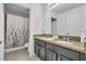 Bathroom with a double sink vanity and a shower with a patterned curtain at 10219 Lenox St, Clermont, FL 34711