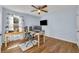 Bedroom with wood flooring, large desk and chair, and lots of natural light at 10219 Lenox St, Clermont, FL 34711