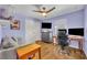 Bedroom with laminate flooring, a ceiling fan, and a gray sofa at 10219 Lenox St, Clermont, FL 34711