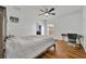 Light-filled bedroom with a bed, wood floors, desk, and an ensuite bathroom at 10219 Lenox St, Clermont, FL 34711