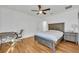 Bedroom featuring wood floors, a ceiling fan, and light-colored walls for a bright interior at 10219 Lenox St, Clermont, FL 34711