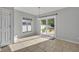 Dining area with sliding glass door to patio, adjacent to a window and a white door at 10219 Lenox St, Clermont, FL 34711