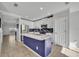 Bright kitchen features a large island with white countertop, stainless appliances, and white cabinetry at 10219 Lenox St, Clermont, FL 34711