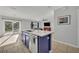 Kitchen island with stainless steel sink and view of the living room and outdoor patio at 10219 Lenox St, Clermont, FL 34711