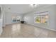 Bright living room featuring tile floors and large windows that provide ample natural light at 10219 Lenox St, Clermont, FL 34711