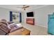 Living room featuring tile flooring, a ceiling fan, and a window with natural light at 10219 Lenox St, Clermont, FL 34711
