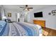 Bright bedroom with a large bed, wood floors, and a clear view of the ensuite bathroom at 10219 Lenox St, Clermont, FL 34711