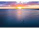 Breathtaking aerial view of a serene sunset over a vast body of water with a sailboat gliding peacefully at 110 N Tremain St # 205, Mount Dora, FL 32757