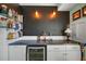 Well-appointed bar area featuring open shelving and a built-in beverage cooler at 110 N Tremain St # 205, Mount Dora, FL 32757