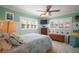 Comfortable bedroom featuring bright, natural light, ceiling fan, and neutral paint at 110 N Tremain St # 205, Mount Dora, FL 32757