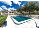 Inviting community pool with ample seating and lush landscaping at 110 N Tremain St # 205, Mount Dora, FL 32757