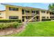 Inviting exterior of a two-story home featuring a well-manicured lawn and charming walkway at 110 N Tremain St # 205, Mount Dora, FL 32757