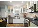 Bright kitchen featuring stainless steel appliances, white cabinets, and a undermount sink at 110 N Tremain St # 205, Mount Dora, FL 32757