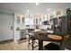 Well-lit kitchen with stainless steel appliances, white cabinets, and an island with seating at 110 N Tremain St # 205, Mount Dora, FL 32757