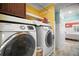 Functional laundry area with modern washer and dryer plus storage at 110 N Tremain St # 205, Mount Dora, FL 32757