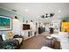 Open-concept living room features a bright kitchen, neutral tones, and wicker seating at 110 N Tremain St # 205, Mount Dora, FL 32757