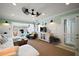 Bright living room boasts neutral tones, ceiling fan, and white wainscoting at 110 N Tremain St # 205, Mount Dora, FL 32757