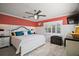 Inviting bedroom with wood-look floors, shuttered window, and white paneled walls at 110 N Tremain St # 205, Mount Dora, FL 32757