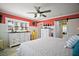 Spacious bedroom featuring warm red walls, natural light, and wood-look floors at 110 N Tremain St # 205, Mount Dora, FL 32757