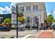 Street view showcasing the building exterior, signage, and brick street at 110 N Tremain St # 205, Mount Dora, FL 32757