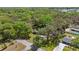 An aerial shot showcases the property's wooded surroundings and proximity to a lake at 1107 Valley Rd, Fruitland Park, FL 34731