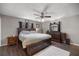 Spacious bedroom featuring a king-sized bed with dark wood furniture and a ceiling fan at 1107 Valley Rd, Fruitland Park, FL 34731