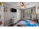 Comfortable bedroom featuring a ceiling fan, closet, and natural light from the window at 1107 Valley Rd, Fruitland Park, FL 34731