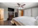 Bedroom featuring a bed, dresser, TV, and closets at 1107 Valley Rd, Fruitland Park, FL 34731