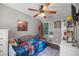 bedroom with themed decor, ceiling fan, and neutral-toned walls and trim at 1107 Valley Rd, Fruitland Park, FL 34731