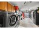 A well-organized garage with washer, dryer, and storage at 1107 Valley Rd, Fruitland Park, FL 34731