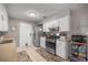 Well-lit kitchen with white cabinetry and stainless steel appliances at 1107 Valley Rd, Fruitland Park, FL 34731